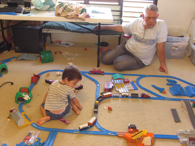 Mikey and Don watch the train snake its way through the switches.
