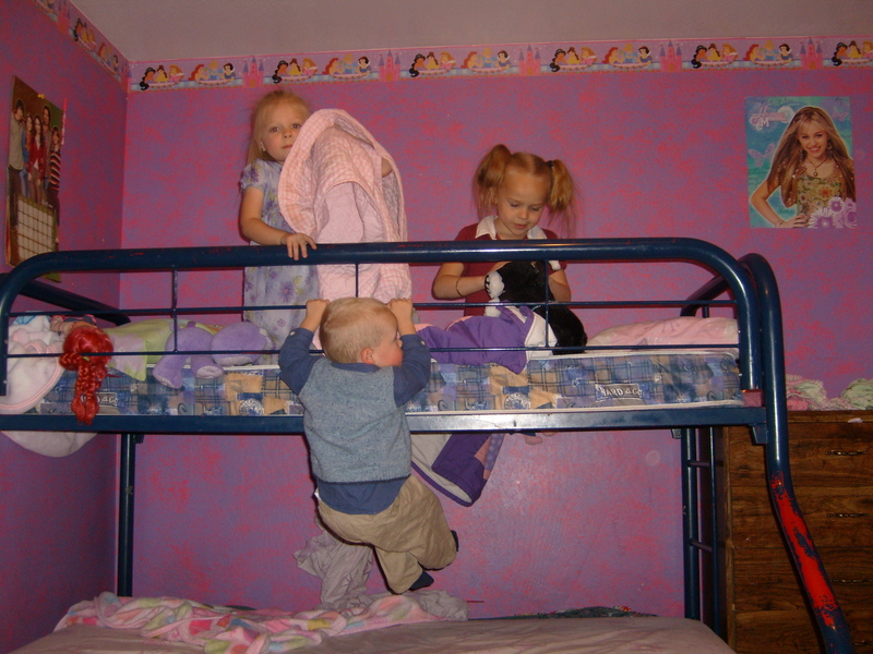 Briyanna in purple, Hollie in red, Caleb doing a pull-up