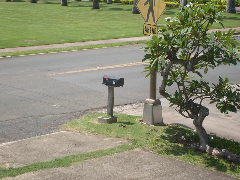 Here is our original mailbox, as seen from the front porch. It is only balancing on top of its post. It is not really attached.